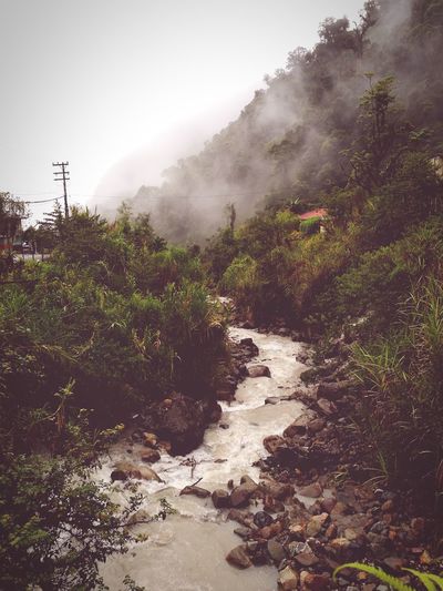 Scenic view of river against a cloudy foggy sky