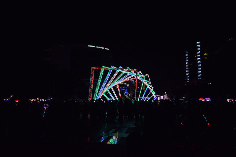 Illuminated ferris wheel at night