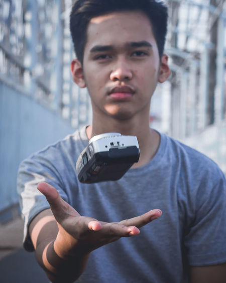 Portrait of young man catching camera
