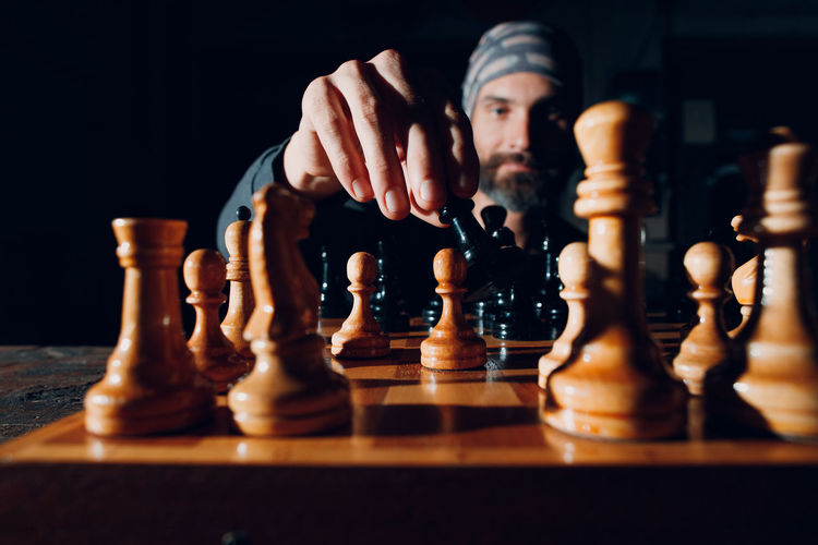 Low angle view of man playing on chess board