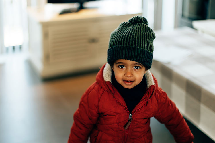 Portrait of a smiling toddler dressed and ready to go out in a cold winter day