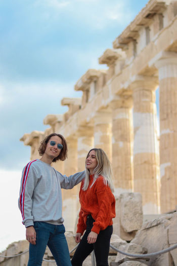 Young tourist couple in love and having fun at the acropolis of greece