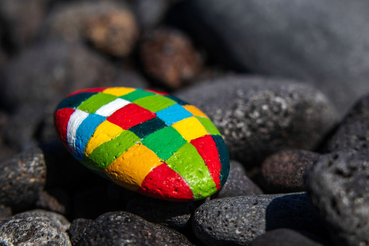 Close-up of multi colored ball on rocks