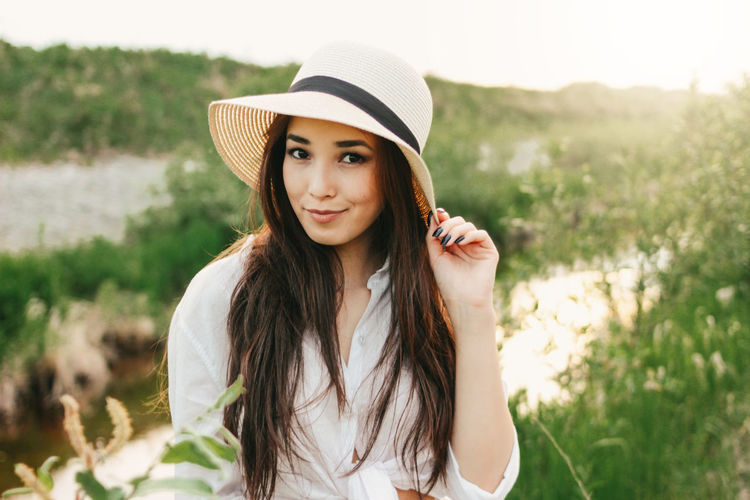 Portrait of beautiful young woman in hat