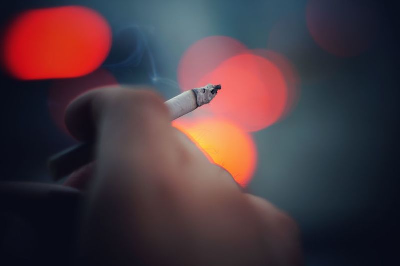 Close-up of a hand holding cigarette