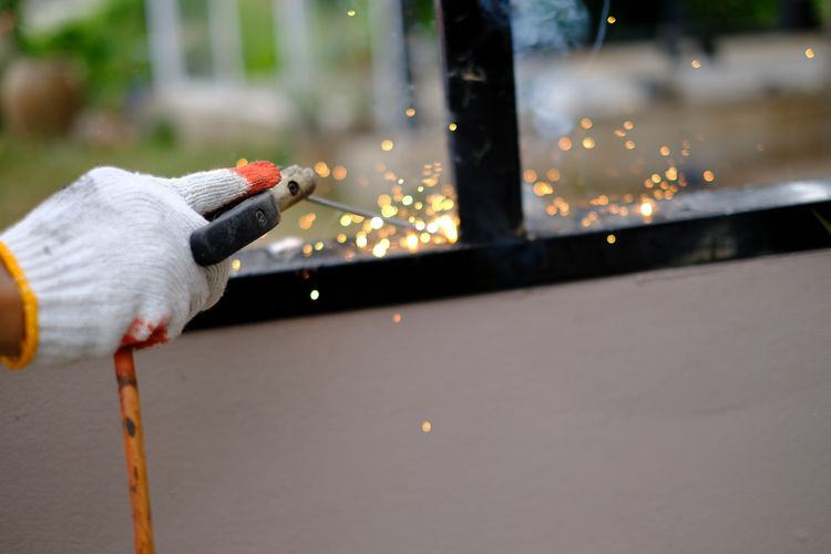 Welder technician are welding steel with sparks flying