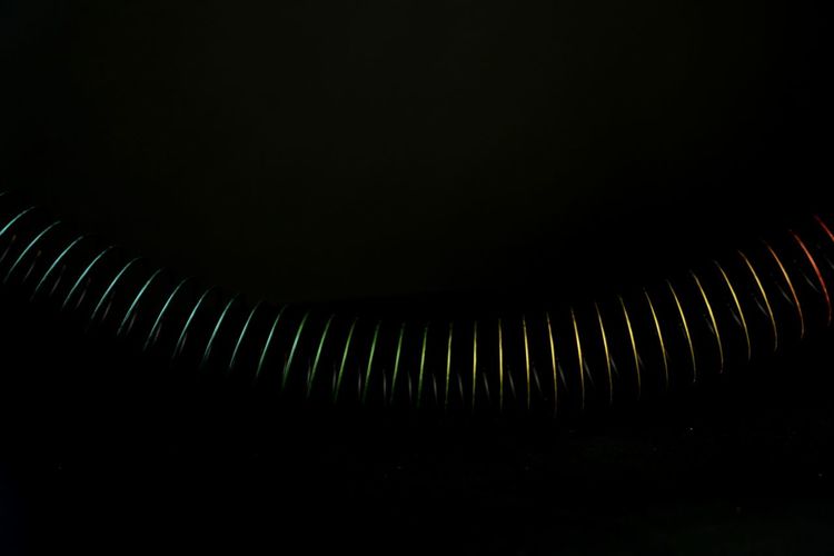 Close-up of spiral metal against black background