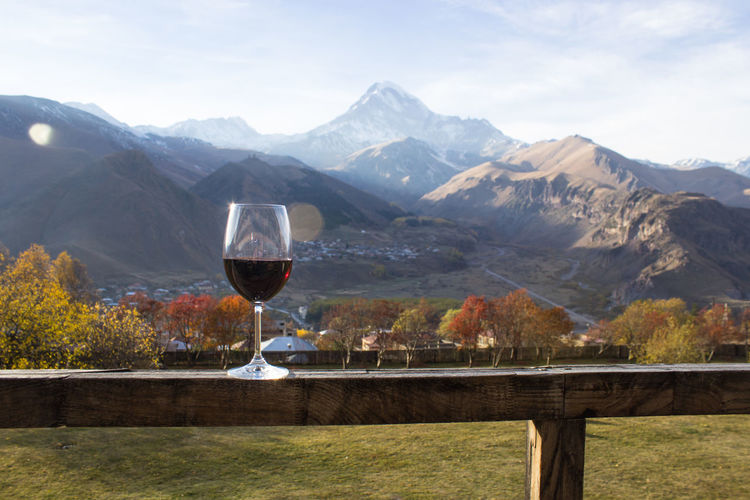 Glass of red wine with mountain view on the background