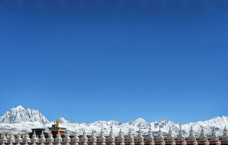 Panoramic view of buildings against blue sky