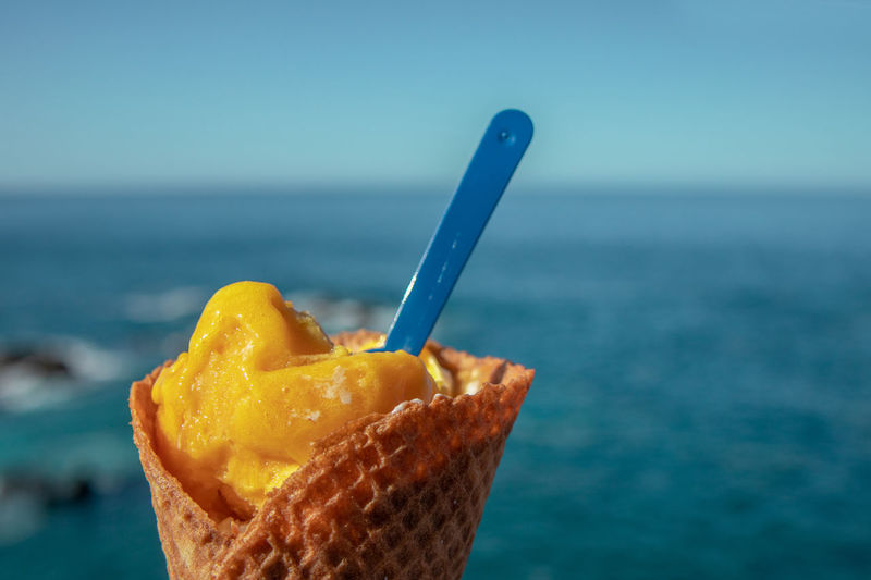 Close-up of ice cream against sea