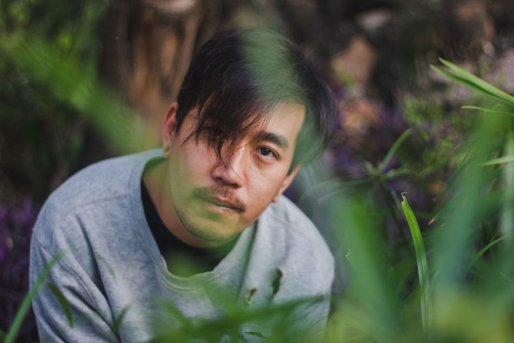 Portrait of young man sitting outdoors