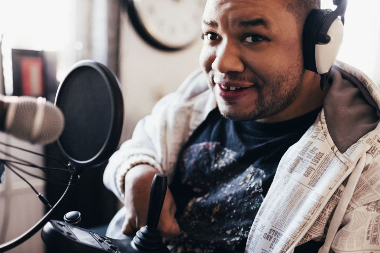Portrait of disabled musician with headphones in studio