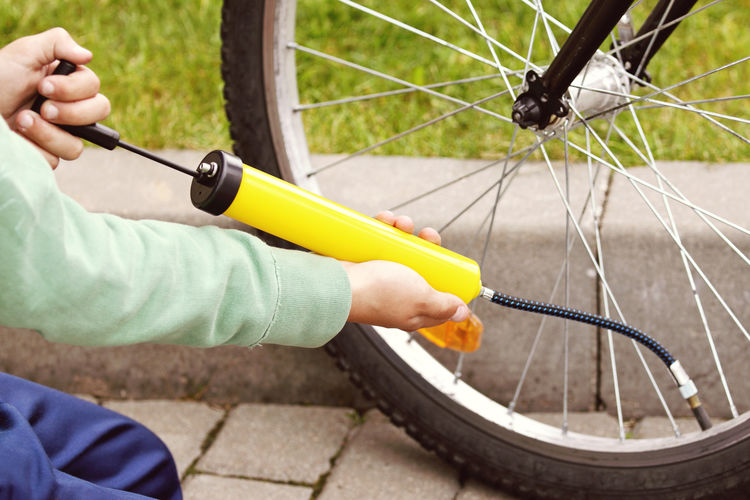 Boys hands pumping bicycle tire