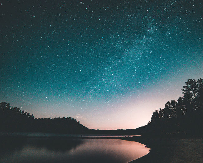 SCENIC VIEW OF LAKE AGAINST STAR FIELD