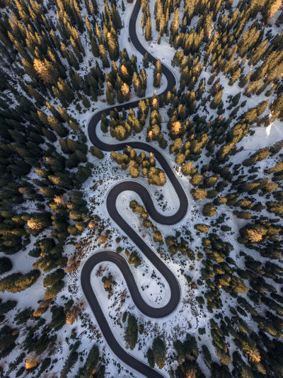 Aerial view of curved road at sunset.
snake road,dolomities,italy