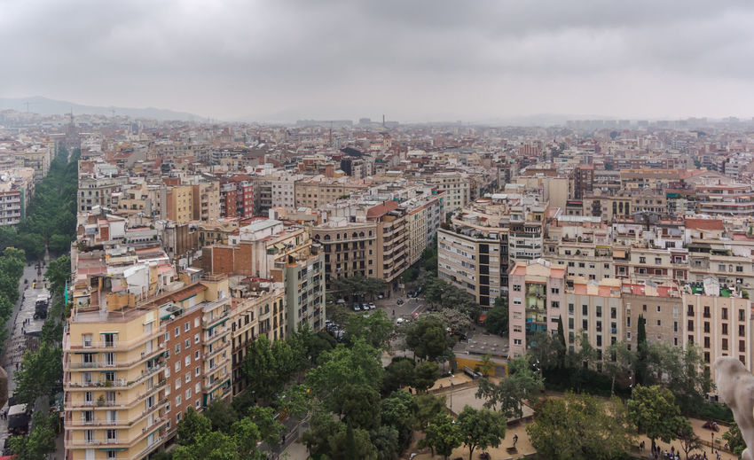 View to barcelona city from the top of the basilica in a dull, murky day with grey and overcast sky