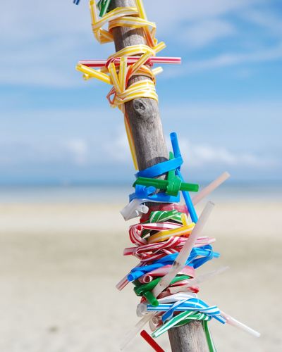 Close-up of multi colored tied up on beach