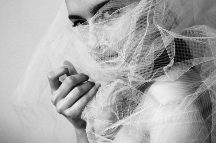 Portrait of beautiful woman in veil at home