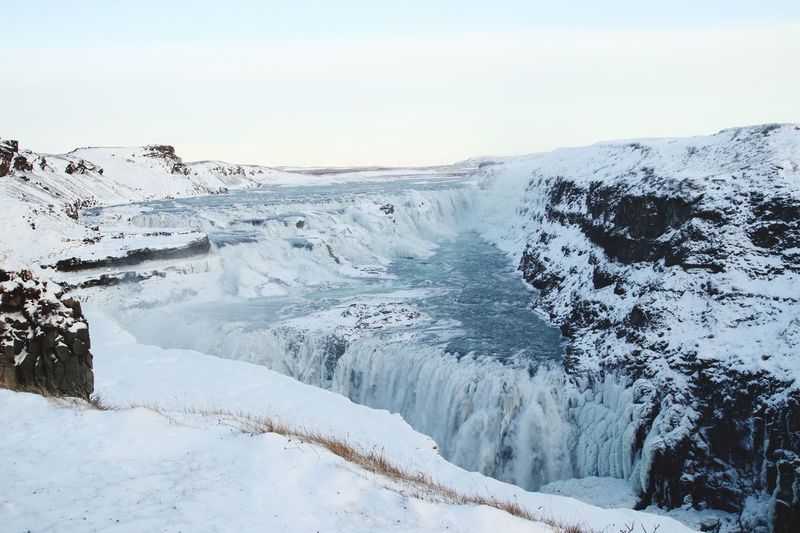 Scenic view of gullfoss falls against sky during winter