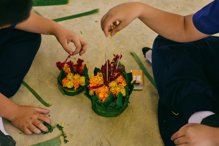 High angle view of people arranging flowers