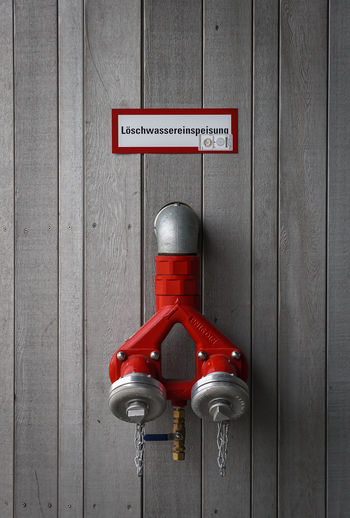 Close-up of fire extinguisher attached on wall
