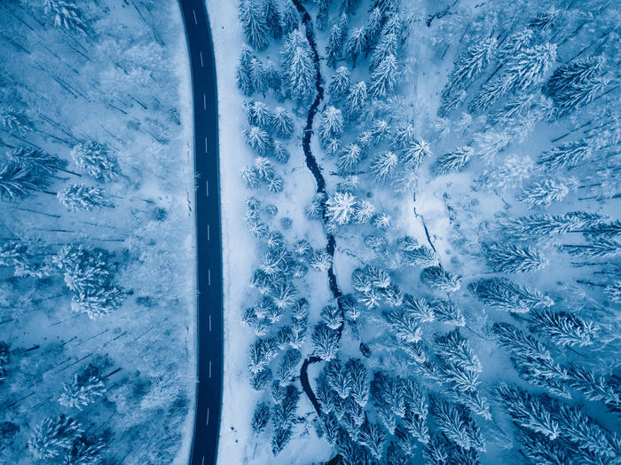 High angle view of road by snow covered field