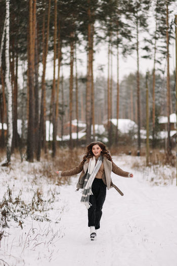Full length of woman on snow covered field