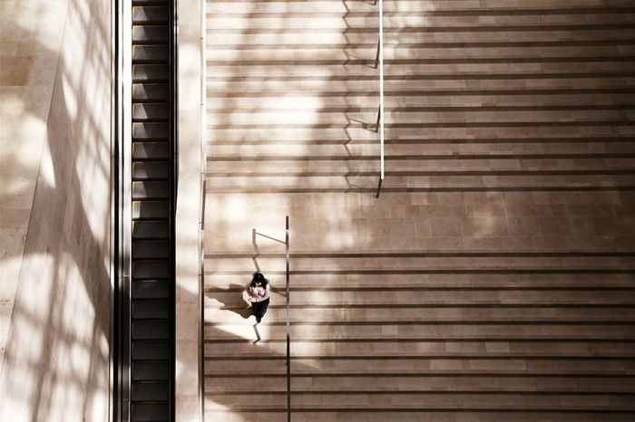High angle view of woman walking on staircase