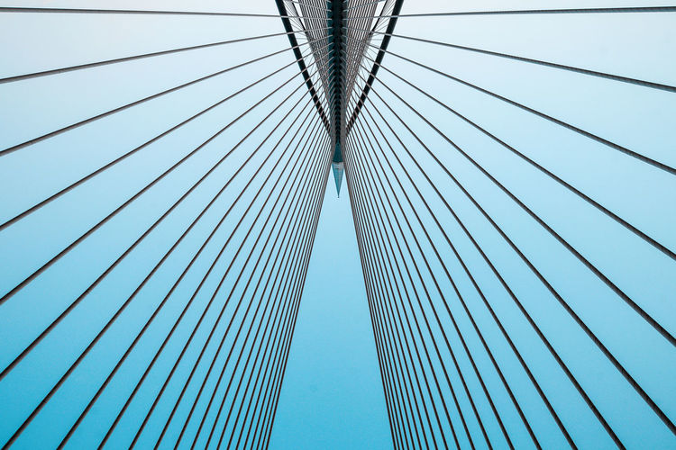 Low angle view of suspension bridge against sky