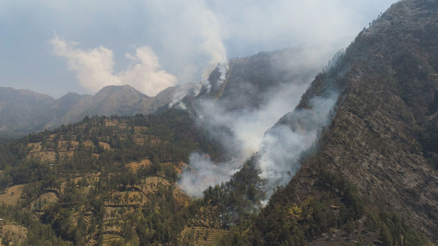 Forest fire and smoke on slopes hills. wild fire in mountains in tropical forest