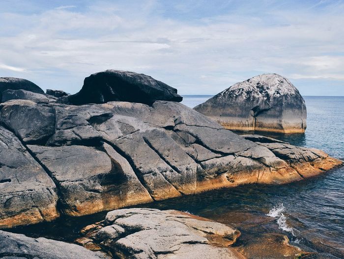 Scenic view of rocky beach against sky
