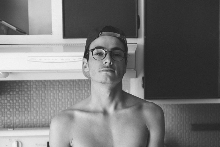 Portrait of shirtless young man at home