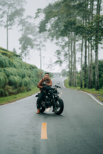 Man riding motorcycle on road