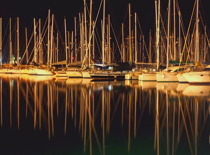 Reflection of sailboats in water