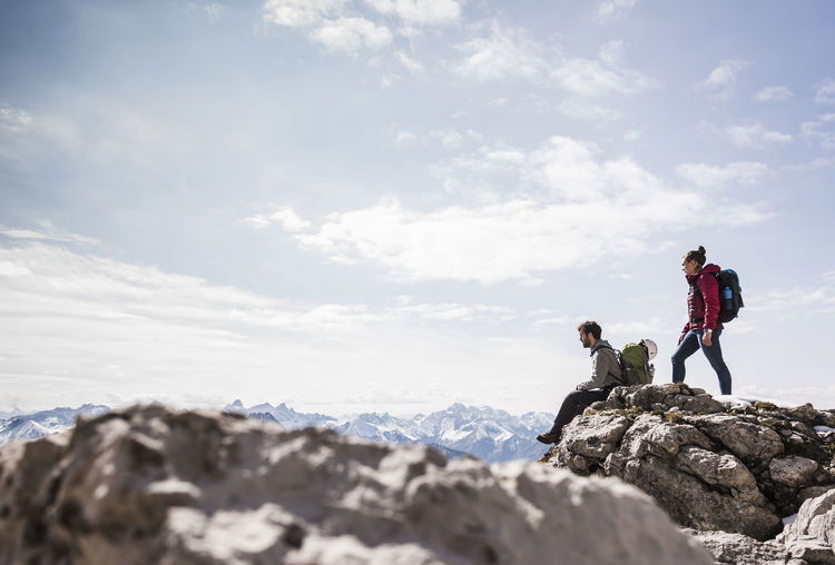 Germany, bavaria, oberstdorf, two hikers on rock in alpine scenery