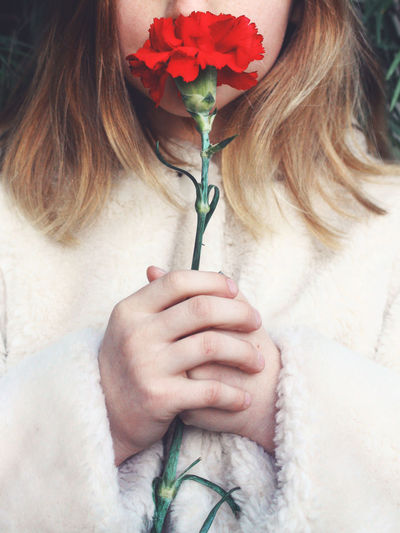Close-up of woman holding flower