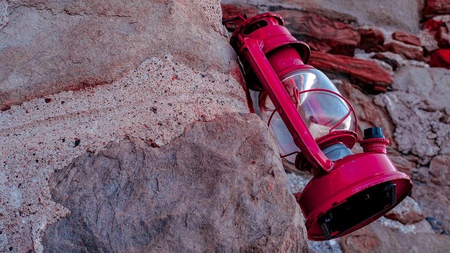 High angle view of container on rock against wall