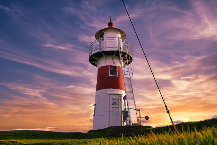 Low angle view of lighthouse against sky during sunset