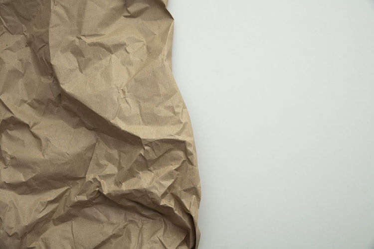 High angle view of crumpled paper on white background