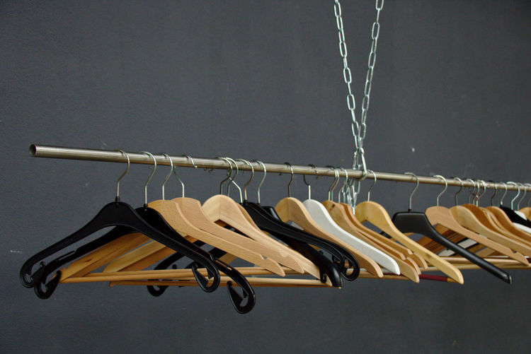 Close-up of clothes hanging on rack against wall
