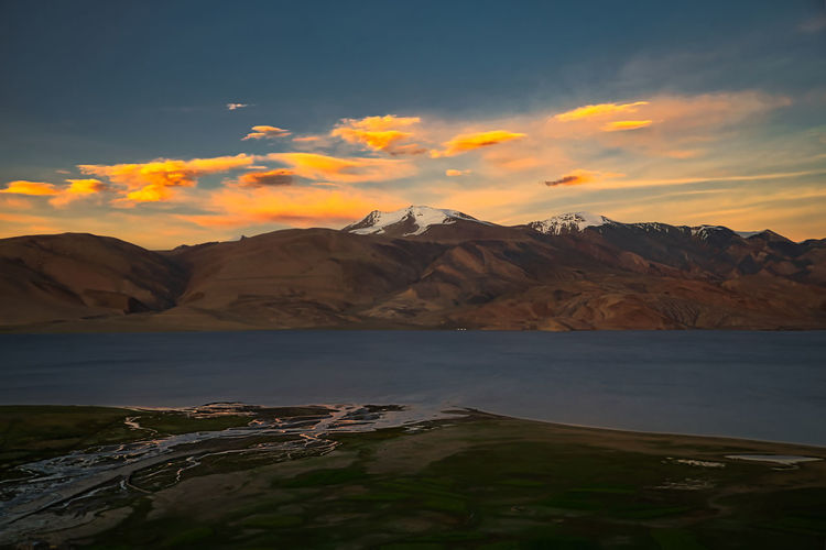 Scenic view of lake and mountains during sunset