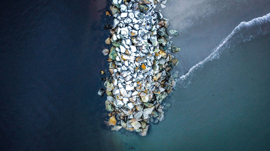 High angle view of sea against breakwater