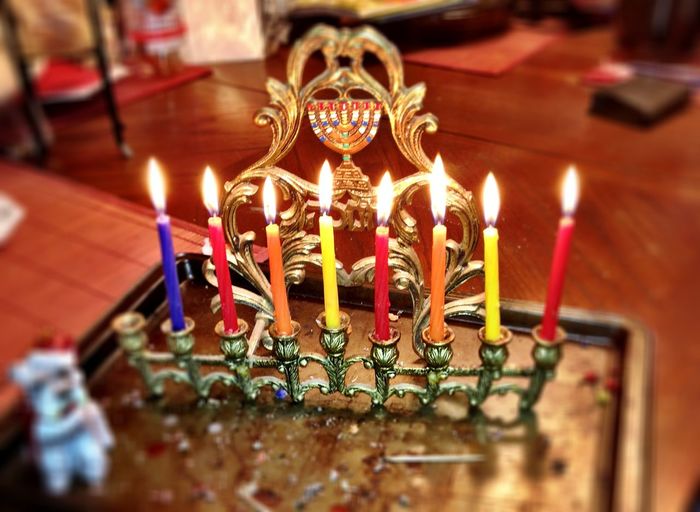 High angle view of burning colorful candles at home during hanukkah