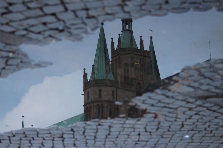 Reflection of erfurt cathedral in puddle