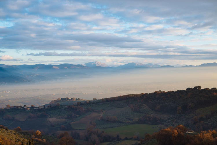 Scenic view of mountains against cloudy sky