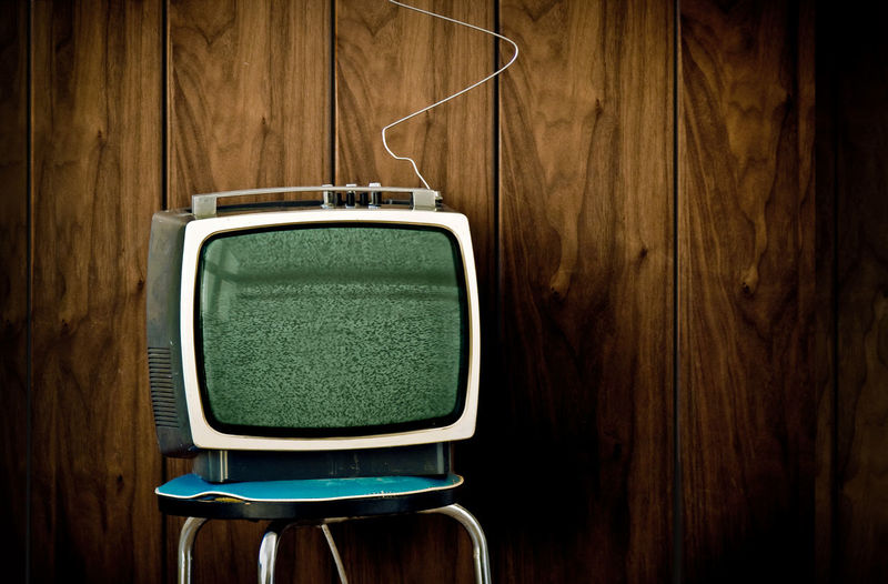 Close-up of television set against wall