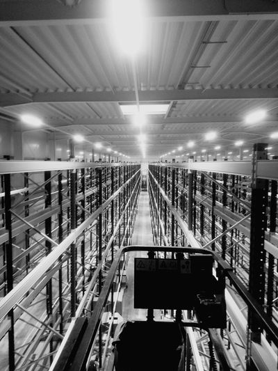 Illuminated electric lights in warehouse at night
