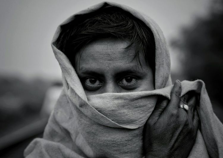 Close-up portrait of man covered with blanket