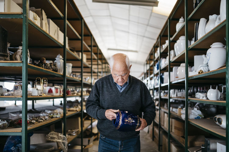 Elderly man reviewing the ceramic piece