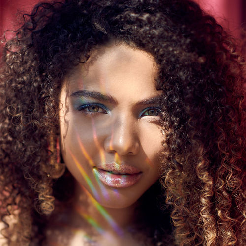 Portrait of beautiful young woman with curly hair